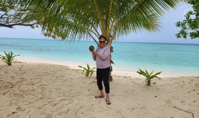 Denise Hood- holding coconut on beach